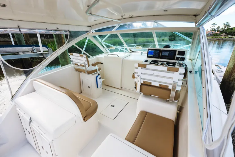 Slide: The Image of 2006 Carolina Classic 32 boat interior with beige seating and modern navigation equipment. - 36
