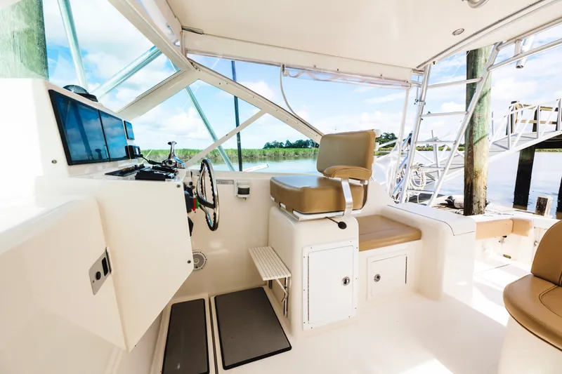 Slide: The Image of Interior view of a 2006 Carolina Classic 32 boat cockpit with helm and seating. - 24