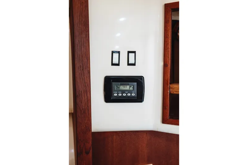 Slide: The Image of 2006 Carolina Classic 32 interior control panel with wooden trim and digital display. - 17