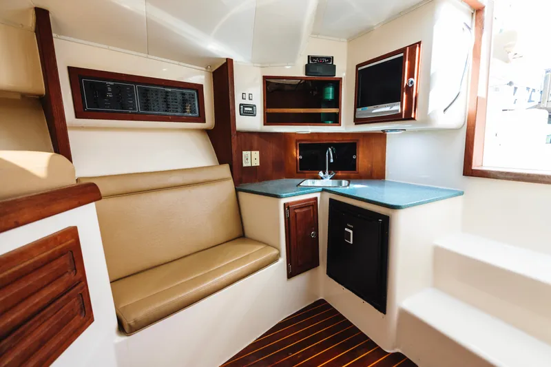 Slide: The Image of Interior of 2006 Carolina Classic 32 boat with kitchenette and seating area. - 14