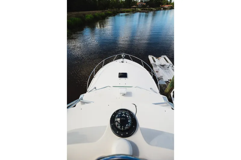Slide: The Image of Bow view of 2006 Carolina Classic 32 boat on calm river water. - 32