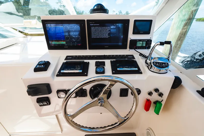 Slide: The Image of Helm of 2006 Carolina Classic 32 boat with modern navigation and control systems. - 20