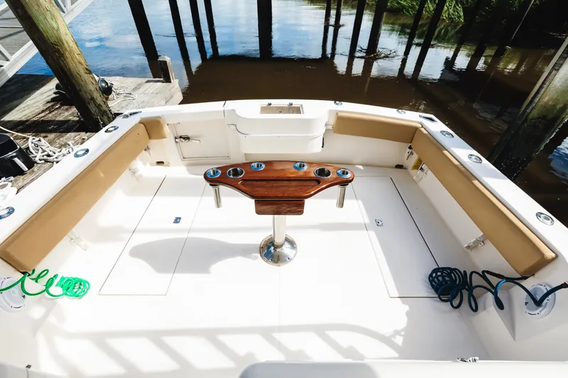 Slide: The Image of 2006 Carolina Classic 32 boat deck with seating and fishing rod holders. - 26