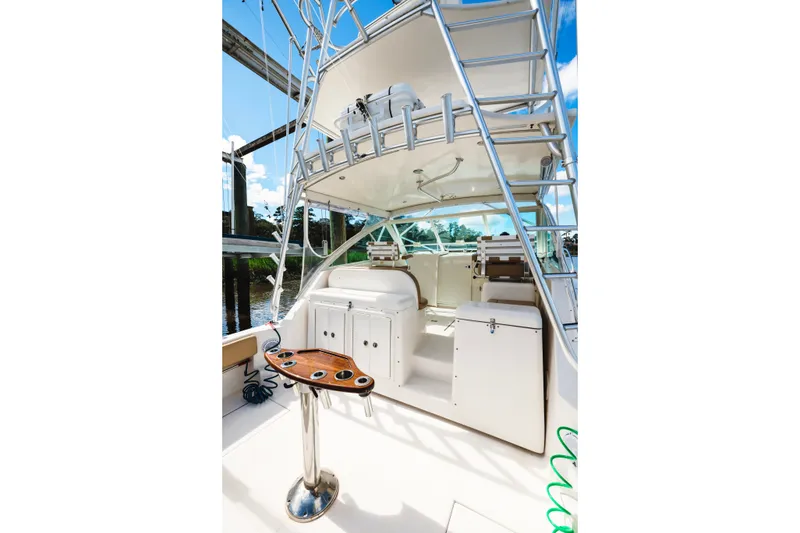 Slide: The Image of 2006 Carolina Classic 32 boat interior with fishing rod holders and seating area. - 27