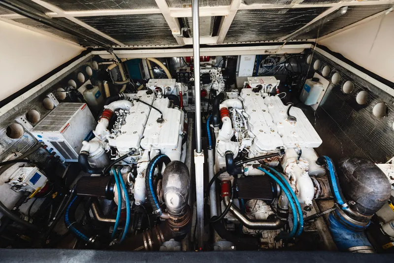 Slide: The Image of Engine room of a 2006 Carolina Classic 32 boat, featuring dual engines and mechanical components. - 39
