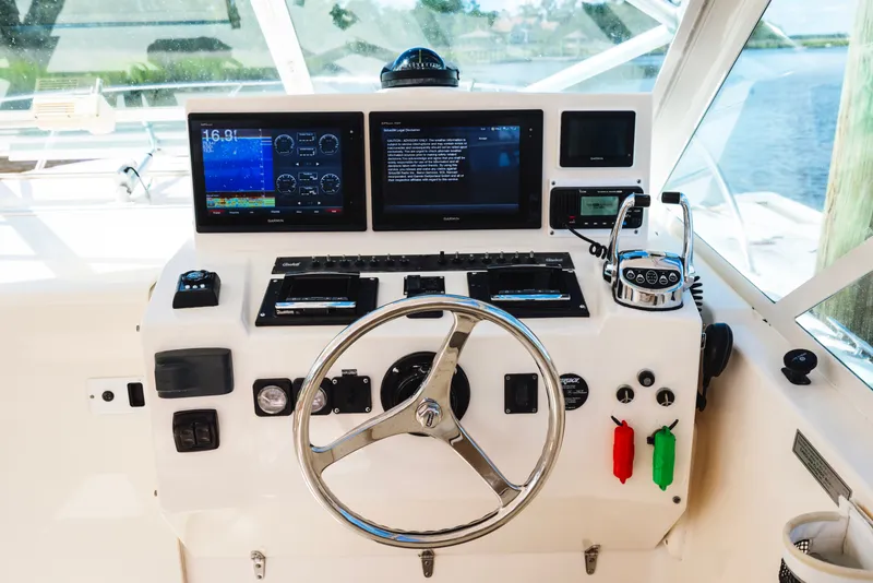 Slide: The Image of Helm of 2006 Carolina Classic 32 boat with navigation instruments and steering wheel. - 19