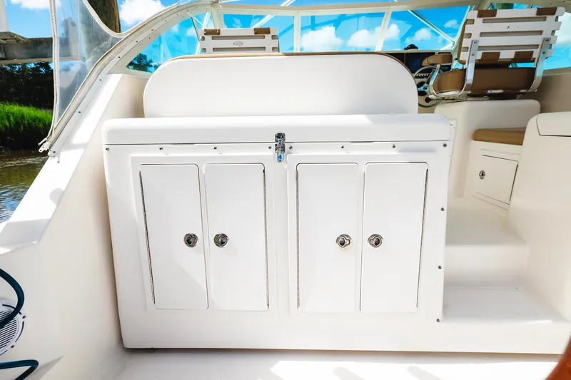 Slide: The Image of 2006 Carolina Classic 32 boat interior with white storage cabinets and seating. - 29