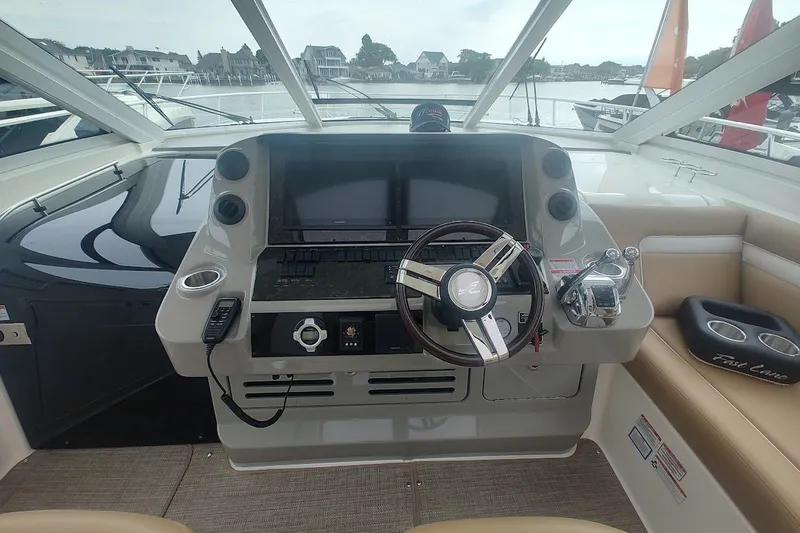 Slide: The Image of Helm of 2010 Sea Ray Sundancer 540 yacht with steering wheel and navigation controls. - 14