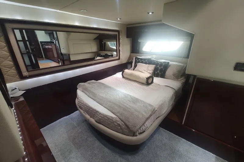 Slide: The Image of Luxurious bedroom interior of 2010 Sea Ray Sundancer 540 yacht with elegant bedding and large mirror. - 23