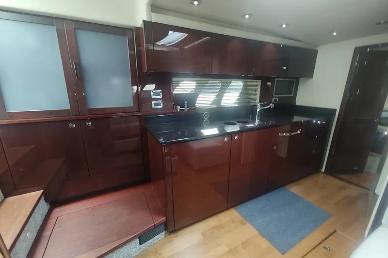 Slide: The Image of Luxurious kitchen interior of 2010 Sea Ray Sundancer 540 yacht with sleek cabinetry and modern appliances. - 22