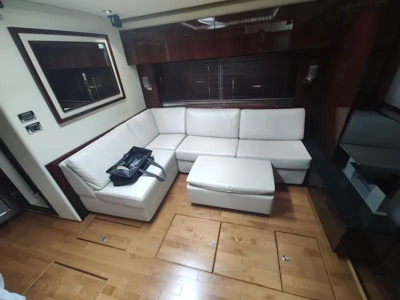 Slide: The Image of Luxurious interior of 2010 Sea Ray 540 Sundancer with white leather sofa and wooden flooring. - 15