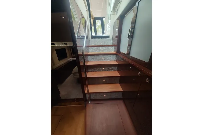 Slide: The Image of Interior staircase of 2010 Sea Ray Sundancer 540 yacht, featuring elegant wood and carpet design. - 20