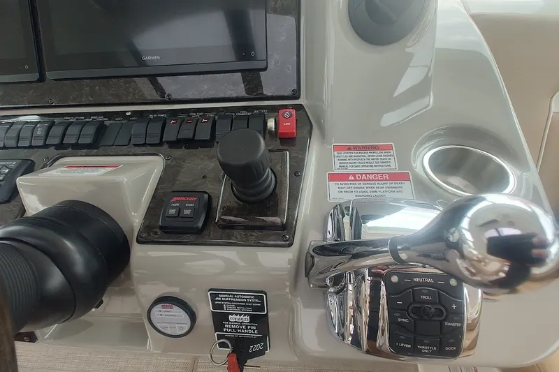 Slide: The Image of Control panel of a 2010 Sea Ray Sundancer 540 yacht with navigation and throttle controls. - 13