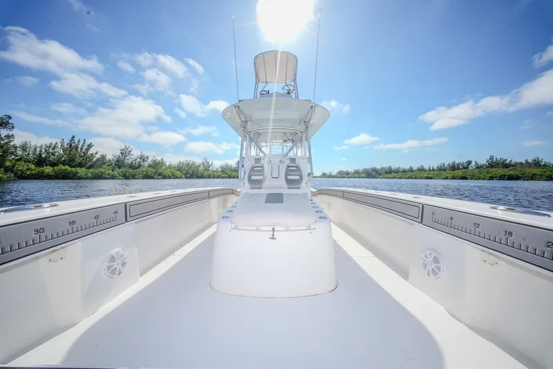 Slide: The Image of 2020 Tideline 365 Offshore boat on a sunny day, surrounded by water and trees. - 59