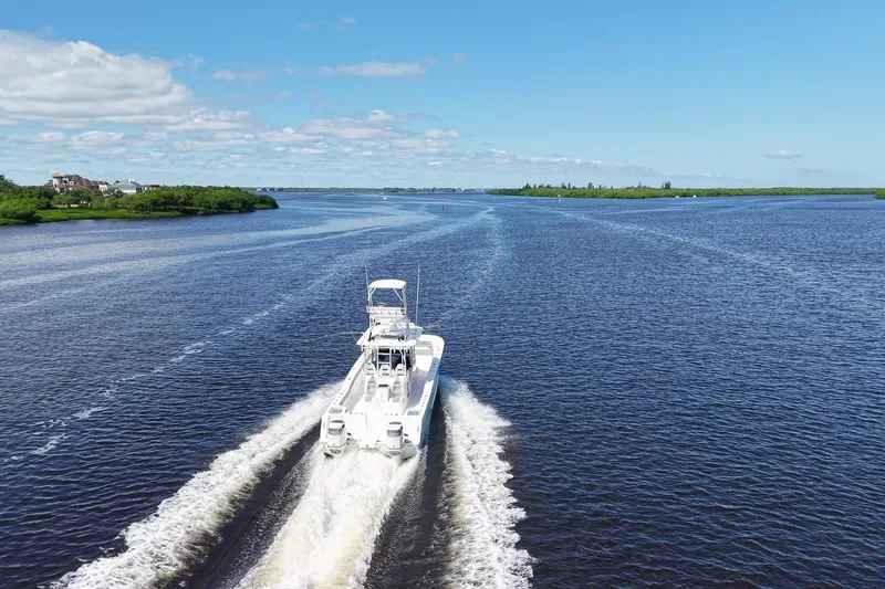 Slide: The Image of Aerial view of 2020 Tideline 365 Offshore boat cruising on a wide river. - 19