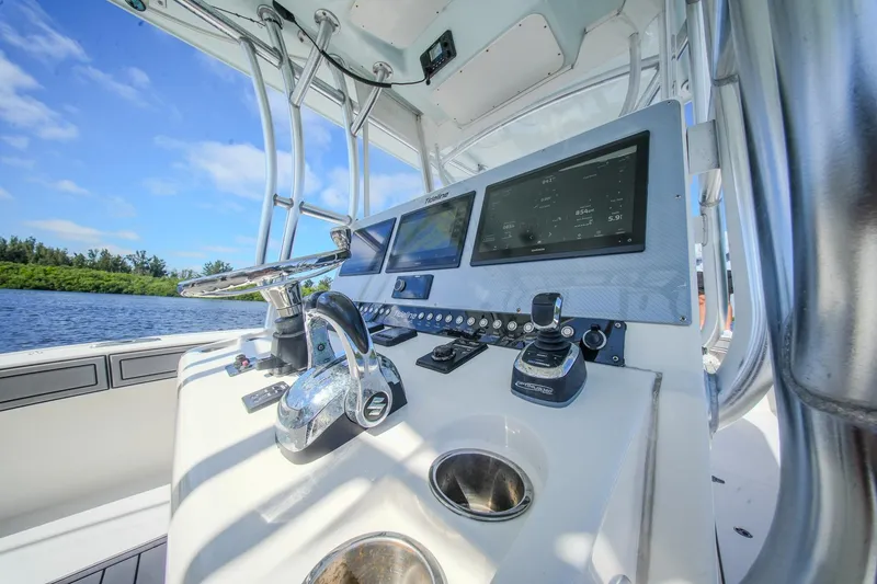 Slide: The Image of Control panel of 2020 Tideline 365 Offshore boat with navigation screens and steering wheel. - 70