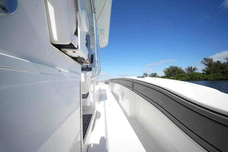 Slide: The Image of 2020 Tideline 365 Offshore boat deck with clear blue sky and lush greenery. - 69