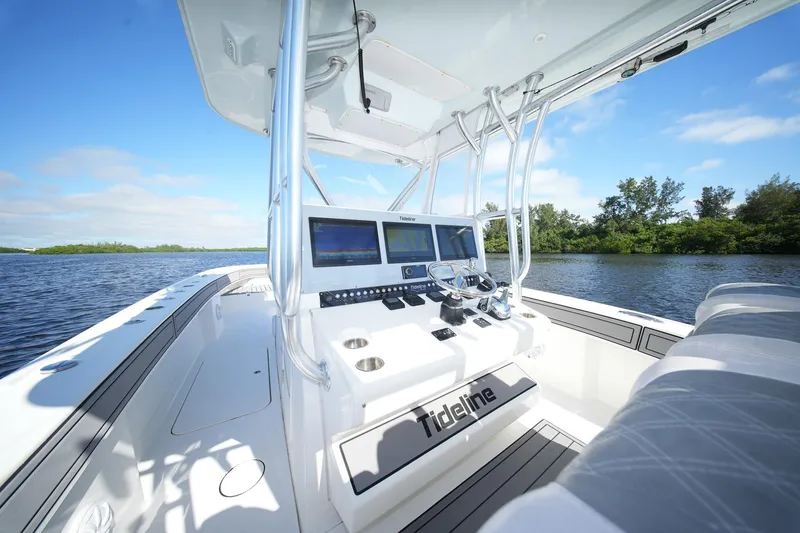 Slide: The Image of 2020 Tideline 365 Offshore boat interior with modern navigation system on a sunny day. - 48