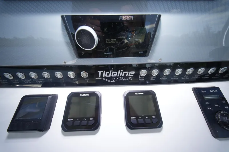 Slide: The Image of Control panel of 2020 Tideline 365 Offshore boat with Suzuki and FLIR displays. - 52