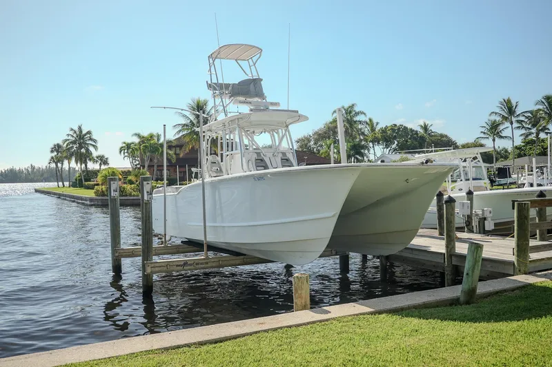 Slide: The Image of 2020 Tideline 365 Offshore boat docked near palm trees and waterfront homes. - 38