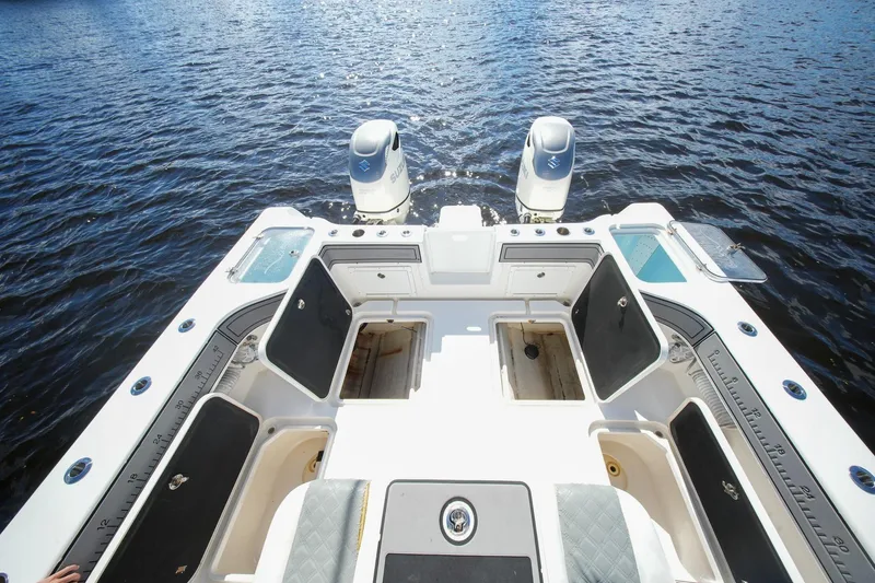 Slide: The Image of 2020 Tideline 365 Offshore boat deck with dual engines on open water. - 86