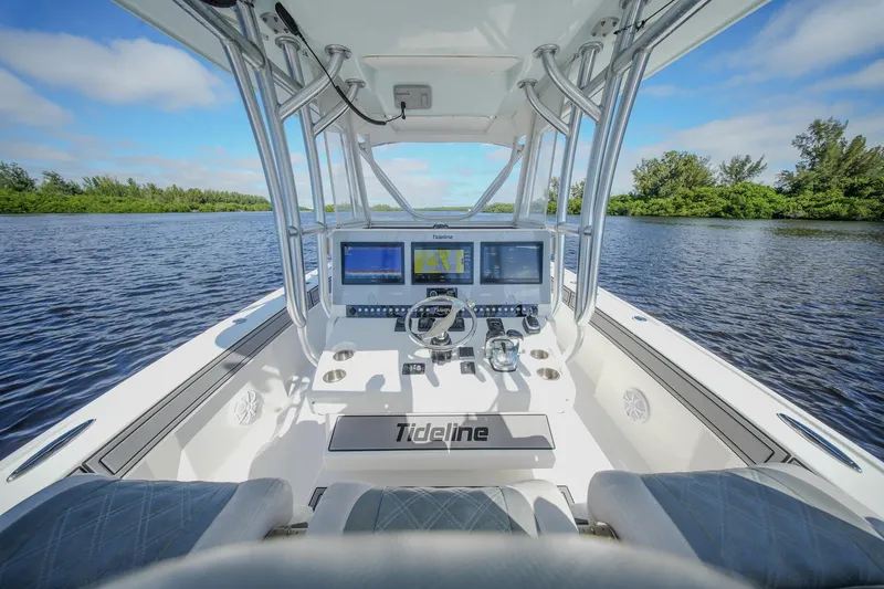 Slide: The Image of 2020 Tideline 365 Offshore boat cockpit with advanced navigation systems on a serene waterway. - 47