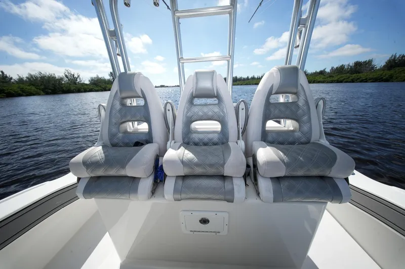 Slide: The Image of Three luxury seats on a 2020 Tideline 365 Offshore boat, with a scenic water backdrop. - 64