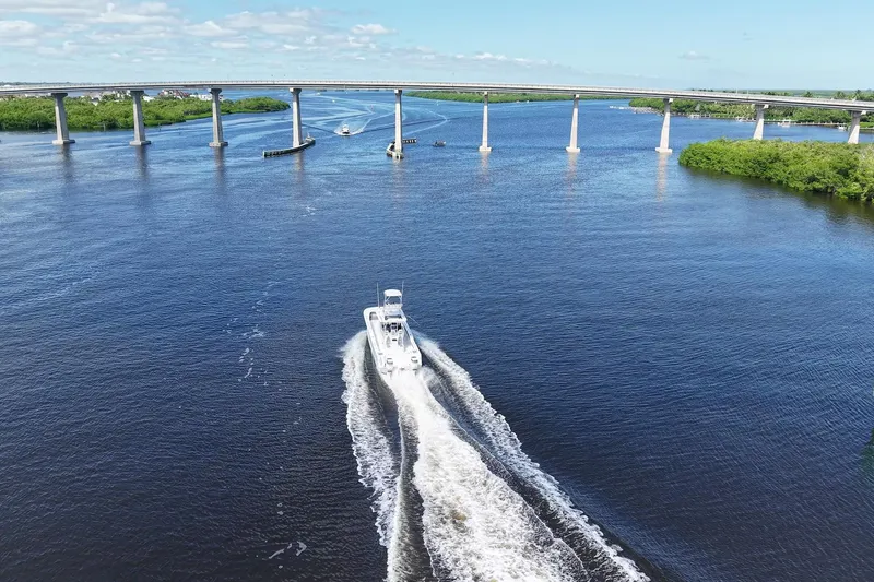 Slide: The Image of Aerial view of 2020 Tideline 365 Offshore boat cruising under a bridge on a sunny day. - 17