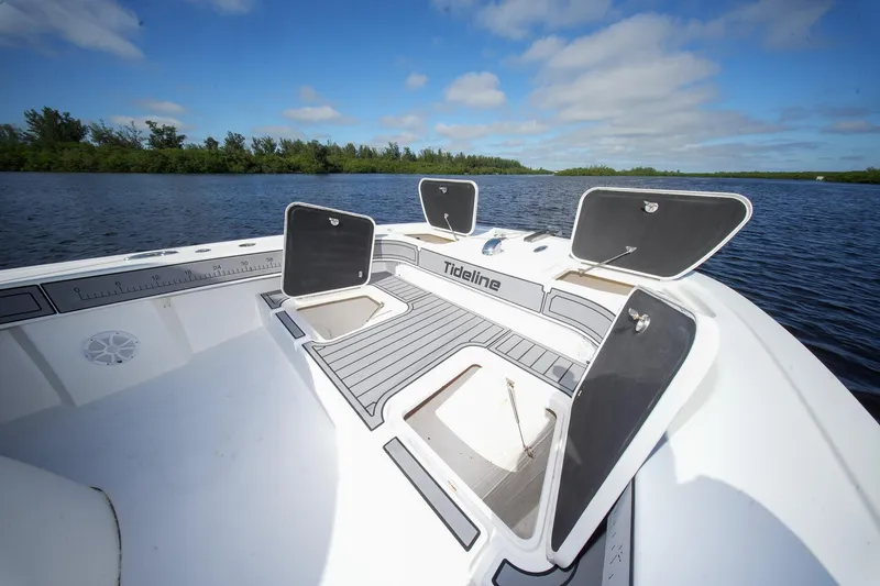 Slide: The Image of 2020 Tideline 365 Offshore boat with open storage compartments on a sunny day. - 57