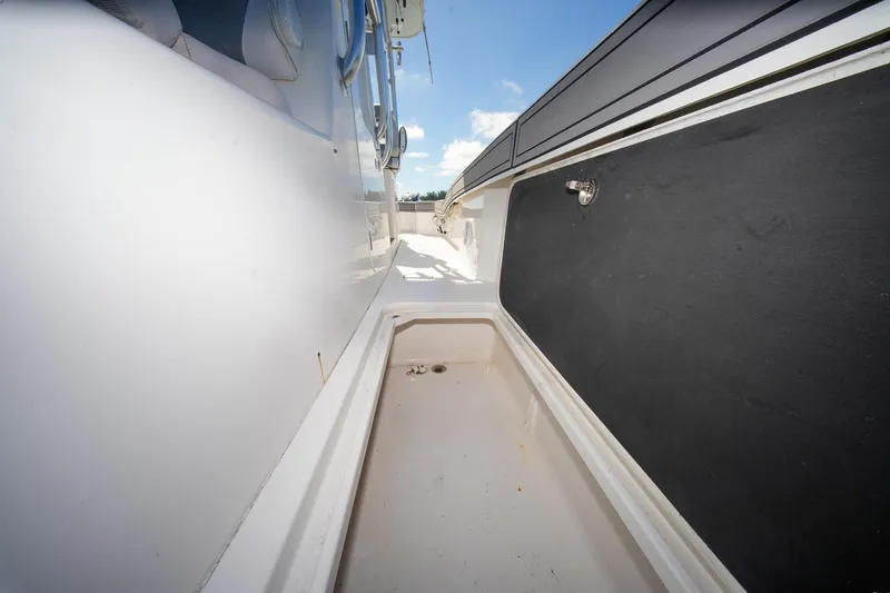 Slide: The Image of 2020 Tideline 365 Offshore boat deck with storage compartment, clear sky background. - 73