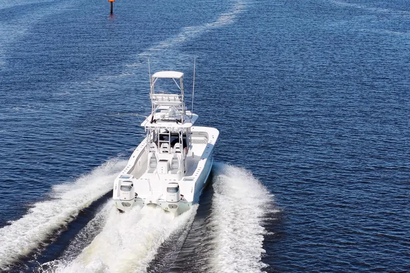 Slide: The Image of 2020 Tideline 365 Offshore boat cruising on open water, rear view. - 20