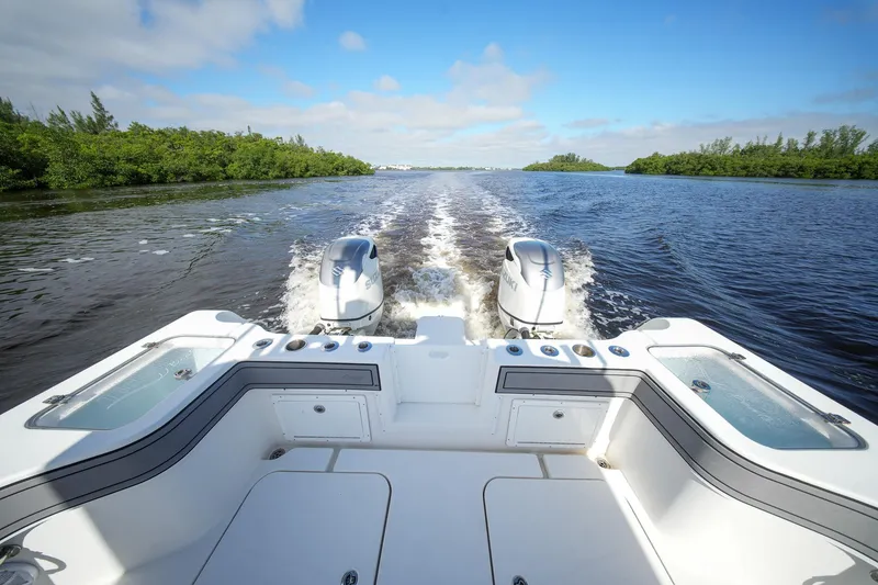 Slide: The Image of 2020 Tideline 365 Offshore boat cruising on a sunny day, twin engines visible. - 37