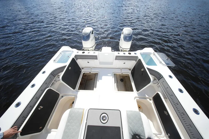 Slide: The Image of 2020 Tideline 365 Offshore boat with open storage compartments on calm water. - 87