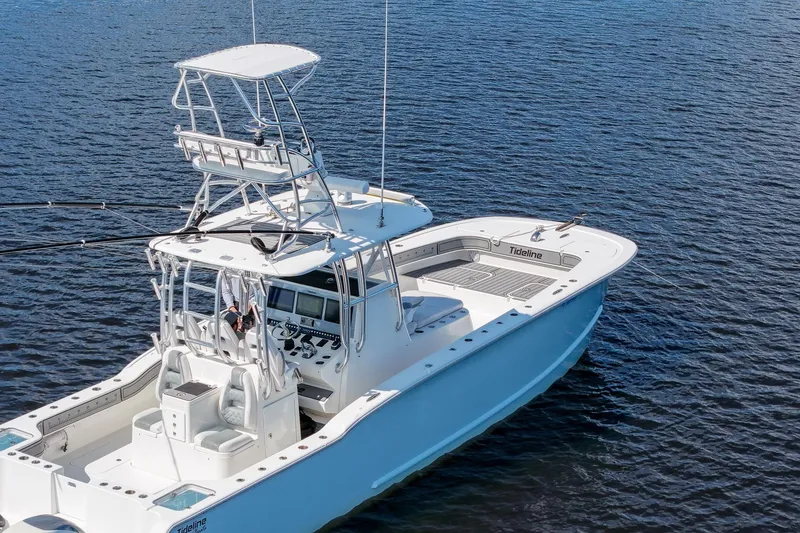 Slide: The Image of 2020 Tideline 365 Offshore boat on calm water, featuring a sleek design and spacious deck. - 29
