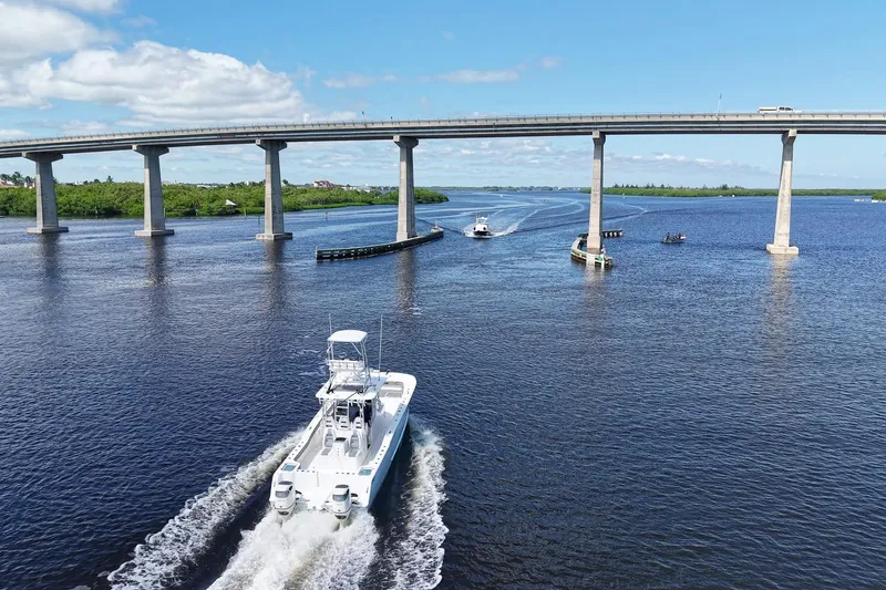 Slide: The Image of A 2020 Tideline 365 Offshore boat cruising under a bridge on a sunny day. - 18