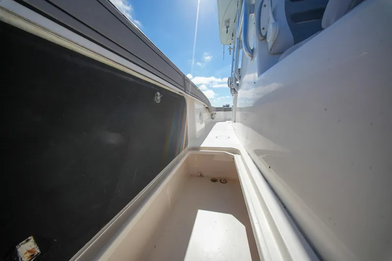 Slide: The Image of 2020 Tideline 365 Offshore boat deck with storage compartment under clear blue sky. - 74