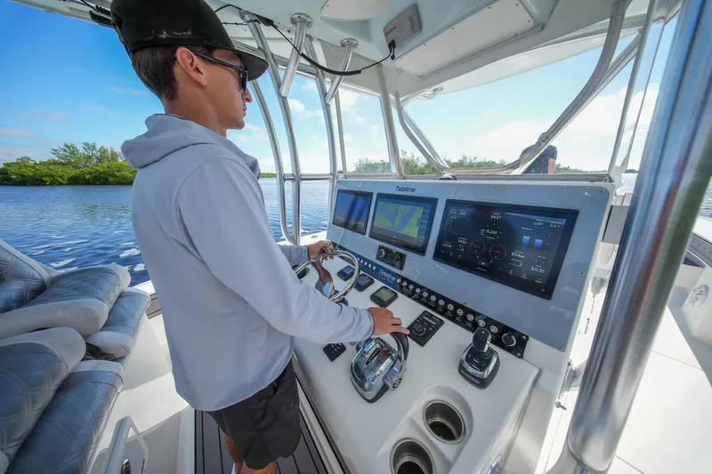 Slide: The Image of Person navigating a 2020 Tideline 365 Offshore boat with advanced control panel. - 41