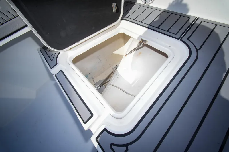 Slide: The Image of Open storage compartment on 2020 Tideline 365 Offshore boat deck. - 58