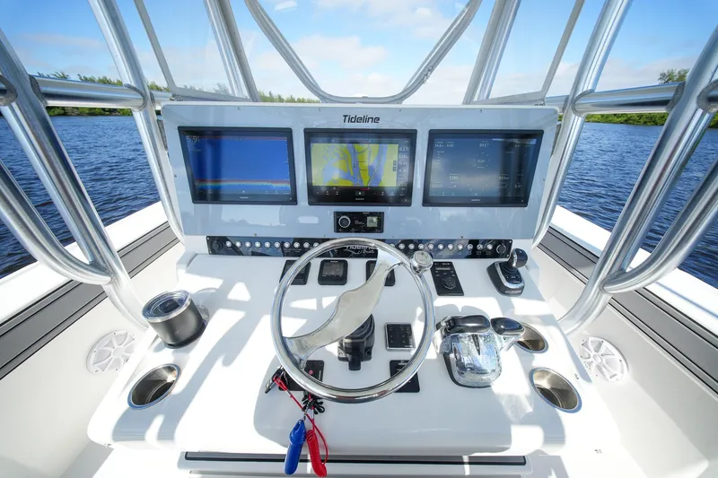 Slide: The Image of 2020 Tideline 365 Offshore boat dashboard with navigation screens and controls on open water. - 43