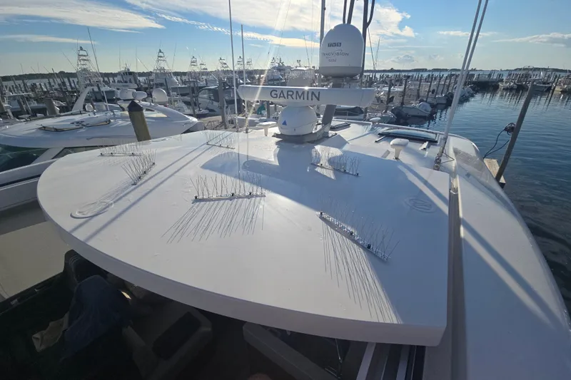 Slide: The Image of 2022 Riviera 505 SUV yacht with Garmin radar, docked at marina under clear sky. - 81