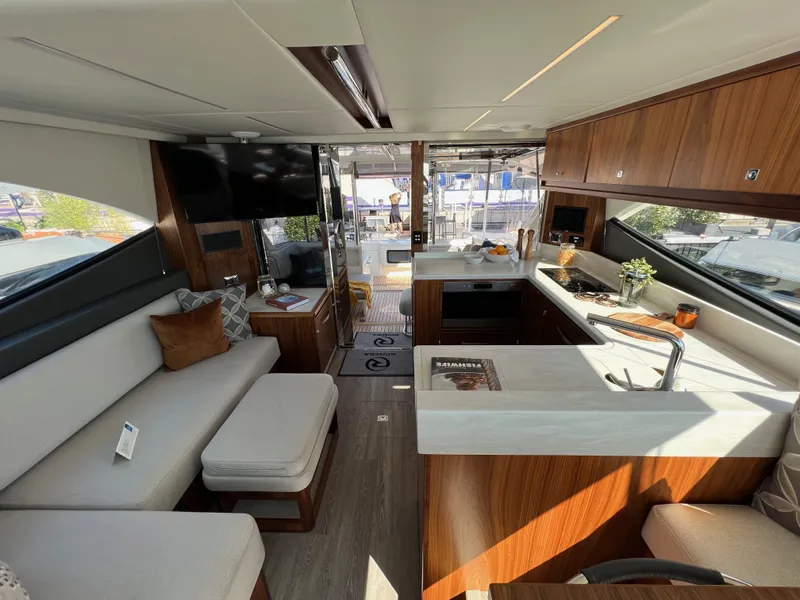 Slide: The Image of Luxurious interior of 2022 Riviera 505 SUV yacht with modern kitchen and seating area. - 18