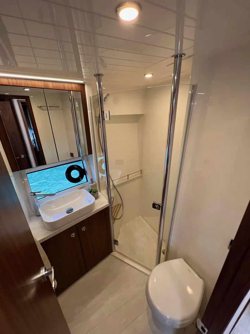 Slide: The Image of Luxurious bathroom in 2022 Riviera 505 SUV yacht with modern fixtures and elegant design. - 31