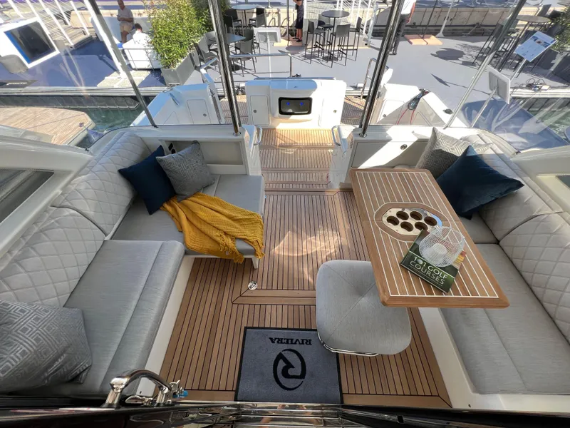 Slide: The Image of Luxurious 2022 Riviera 505 SUV yacht interior with elegant seating and wooden table. - 13
