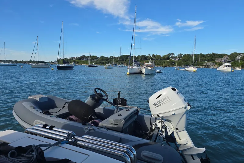 Slide: The Image of Boats anchored in a scenic harbor with a 2022 Riviera 505 SUV. - 80