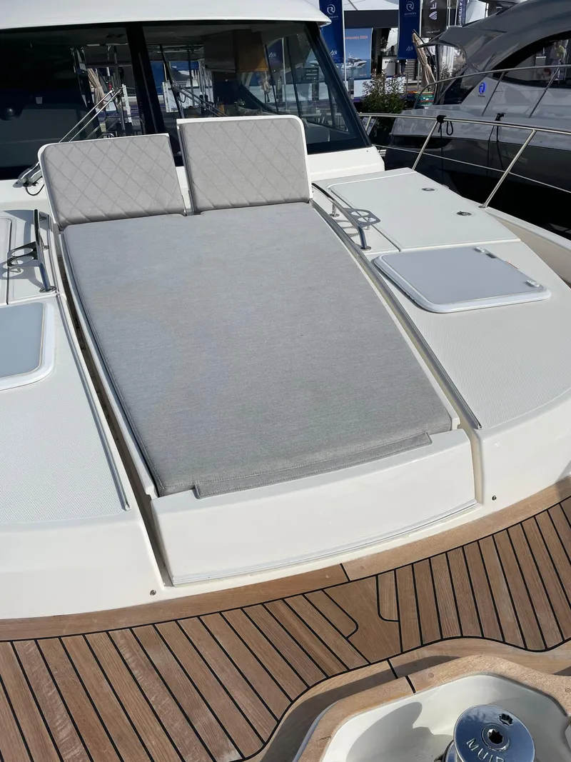 Slide: The Image of 2022 Riviera 505 SUV yacht with sunbathing deck and luxurious seating. - 45