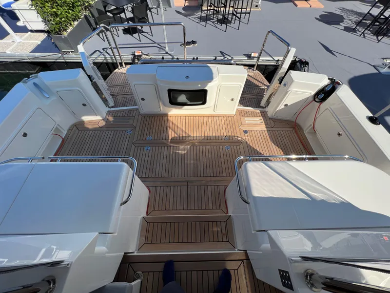 Slide: The Image of 2022 Riviera 505 SUV yacht deck with teak flooring and modern design. - 11