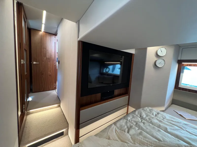Slide: The Image of Luxurious interior of 2022 Riviera 505 SUV yacht with modern bedroom and TV. - 39