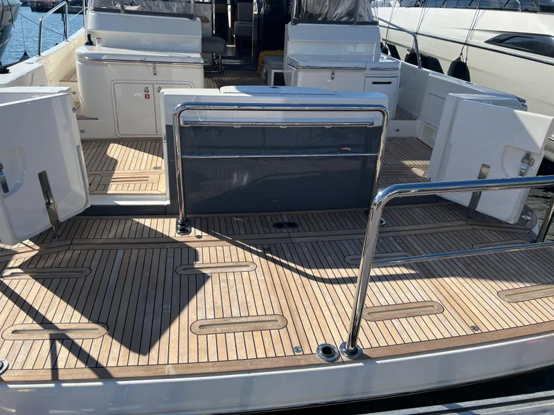 Slide: The Image of 2022 Riviera 505 SUV yacht deck with sleek wooden finish and modern design. - 8