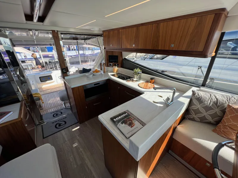 Slide: The Image of Luxurious 2022 Riviera 505 SUV yacht interior with modern kitchen and seating area. - 17