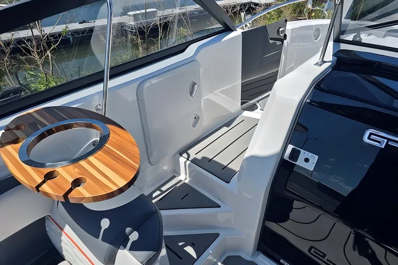 Slide: The Image of Interior of 2025 Grandfort 300 GTS boat with sleek seating and wooden table. - 19